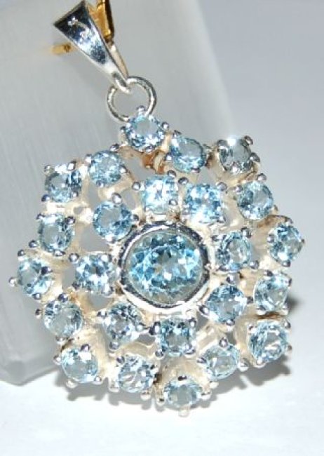 Sternförmiger Silberanhänger mit facettierten Blautopasen